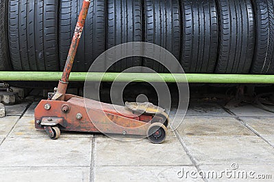 The old floor jack with the car used tire stack Stock Photo