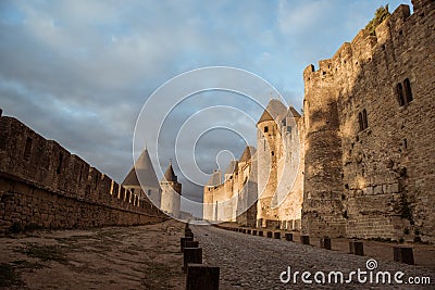 Old fortified french town called Carcassone. Interior of castle at the middle of walls on stony street Stock Photo