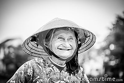 Old friendly woman with vietnamese straw hat Editorial Stock Photo