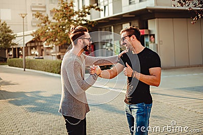 Old friends meet and laughing while shaking hands Stock Photo