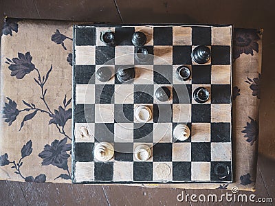 An old game of chess, played with many pieces missing already. Stock Photo