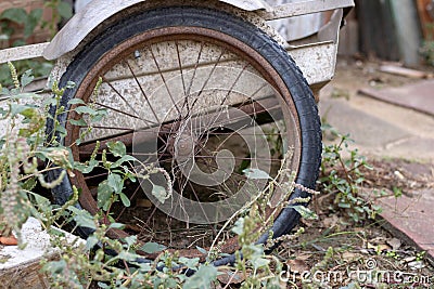Old garden wheelbarrow wheel. Rusted metal. Spoked wheel Stock Photo
