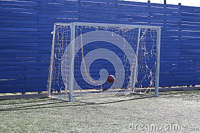 Old gate for football. Gate for football with a torn grid. Sports equipment in the form of goal for football. Behind goal with Stock Photo