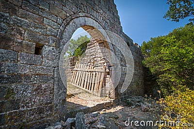 Old gate in a stone fortress wall Stock Photo