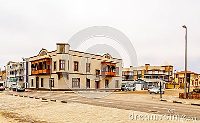 Old German colonial buildings and crossroad with some traffic, S Stock Photo