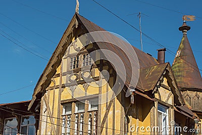 Old German wooden yellow building. Upper part of the building. Stock Photo