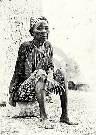 Old Ghanaian lady sits on the stone Editorial Stock Photo