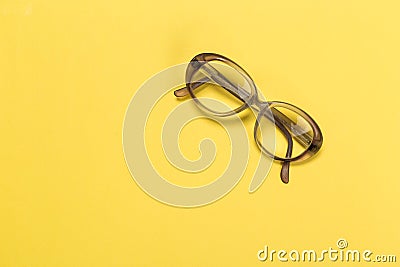 Old glasses on yellow Stock Photo