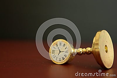 An old golden clock or watch showing the time running out. Stock Photo