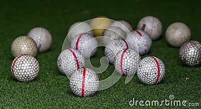 Old golf balls on artificial grass Stock Photo