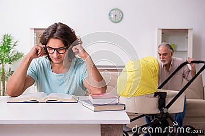 Retired grandfather looking after newborn at home Stock Photo