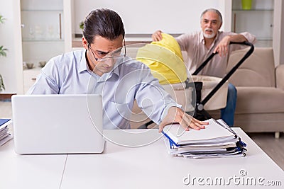 Retired grandfather looking after newborn at home Stock Photo