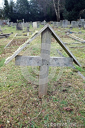 Old Graveyard with Broken and Fallen Crosses and Graves in Overgrown Grass Spooky Stock Photo