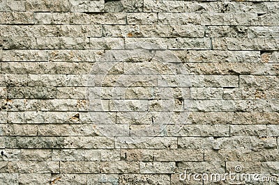 Old gray brick wall of hewn stone Stock Photo