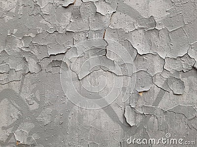 Old gray wall with cracks in plaster and paint. Destruction of graffiti Stock Photo