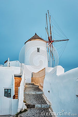 Old greek windmill on Santorini island in Oia town with stairs in street. Santorini, Greece Stock Photo