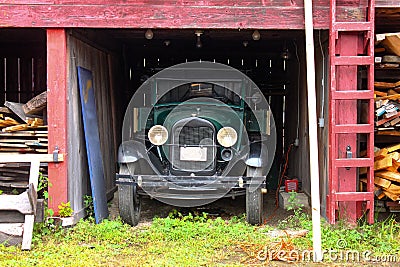 Green Antique truck parked in an old shed Stock Photo