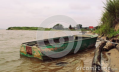 Old green boat with oars Stock Photo