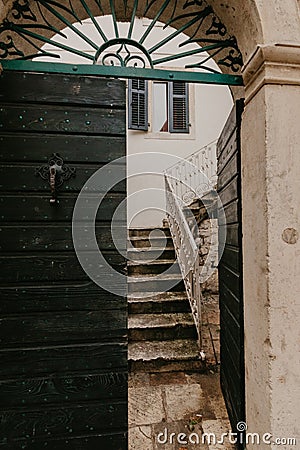 Old green doors that lead to the courtyard Stock Photo