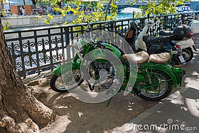 Zurich, Switzerland - August 18, 2019 - old green motorcycle standing parked in the old town Editorial Stock Photo