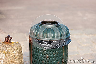 Old green, rusty dustbin on a street Stock Photo