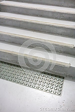 Old grey non-slip mat on floor to white painted stairway closed Stock Photo