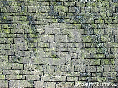 Old grey stone wall made of large irregular blocks covered in patches of moss Stock Photo