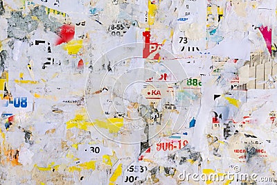 Old grunge ripped torn vintage collage colorful street posters creased crumpled paper surface placard texture background backdrop Stock Photo