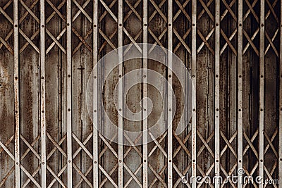 Old grunge rusty shutter folding door for shop closed or business down concept, texture pattern or steel gate Stock Photo