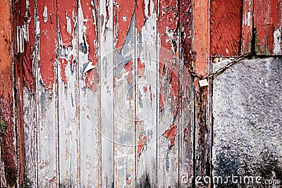 Old grunge and weathered red and white wooden locked door with rusty chain Stock Photo