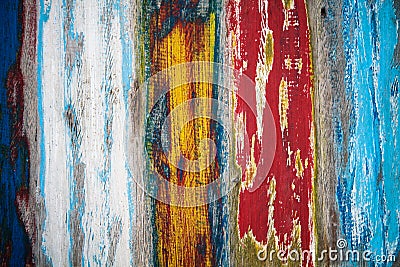 Old grungy weathered colourfully painted wooden wall plank texture in yellow, blue, red and white color mix artistic background Stock Photo