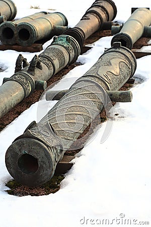 Old guns on snow closeup Stock Photo