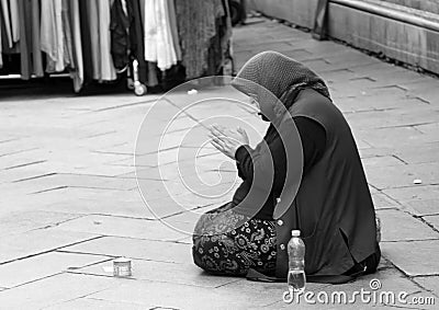 Old Gypsy woman begging on the road Editorial Stock Photo