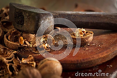 Old hammer with dark aged metal cheek of hammer and scratched polished wood handle closeup. Vintage hammer used as nutcracker with Stock Photo