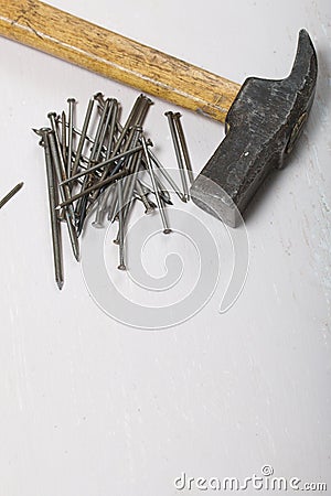 An old hammer and a handful of nails. On white background Stock Photo