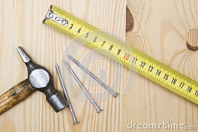Old hammer , tape measure and nails Stock Photo