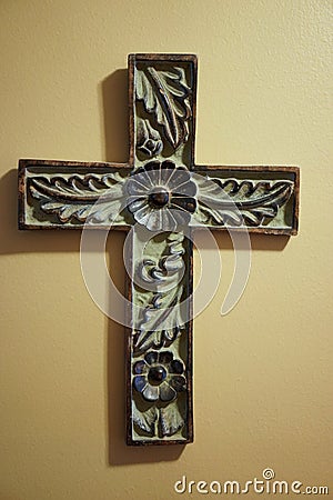 Old hand carved wooden cross with floral design Stock Photo