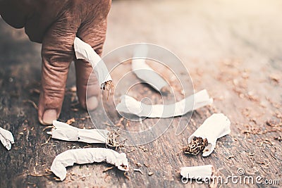 Old hand crushing cigarettes Stock Photo