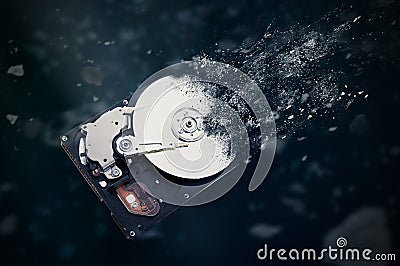 The old hard disk drive is disintegrating in space. Stock Photo