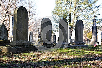 Old headstones backlight on late winter day Stock Photo