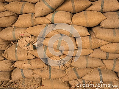 Old hemp sacks containing rice placed stacked. Stock Photo