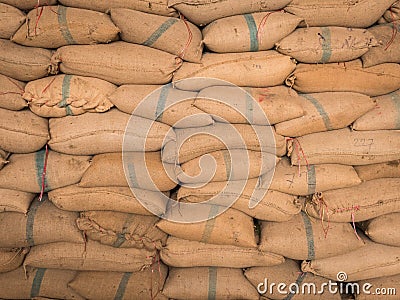 Old hemp sacks stacked in a row. Stock Photo