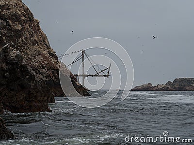 Old historic abandoned bridge ruins at Islas Ballestas Islands pacific ocean rock formation peruvian booby Paracas Peru Stock Photo