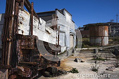 Old Cannery Building with Rusted Tank and Fish Hopper on Cannery Row in Monterey, California Stock Photo