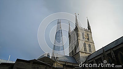 Old historic building on background of modern skyscrapers. Action. Contrast of architecture of buildings of different Stock Photo