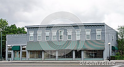 Old, Historic Business Building with Green Striped Awning Stock Photo