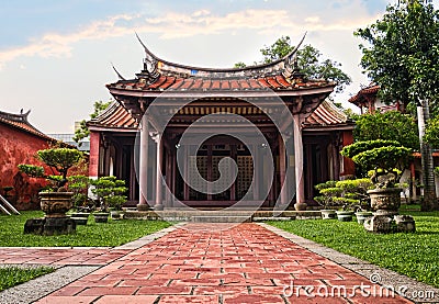 Old historic temple with bonsai alley in front. Traditional red chinese architecture Editorial Stock Photo