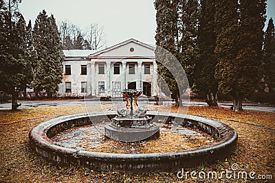 Old, historical, abandoned building Baldone sanatorium and non - working fountain with fish sculptures, Latvia Stock Photo