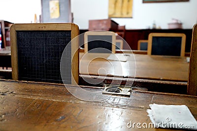 Old historical classroom with wooden desks and chalkboards Stock Photo