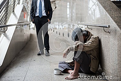 Old homeless man and kind businessman Stock Photo